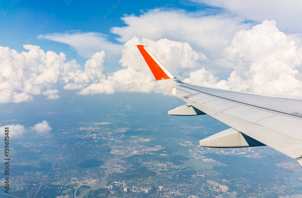 Fototapeta premium View from the airplane window during taking off on a clear summer morning