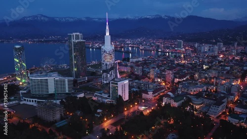 Scenic view from drone of seaside area of Batumi overlooking buildings of modern hotels and high-rise tower of Technological University on spring twilight, Georgia photo