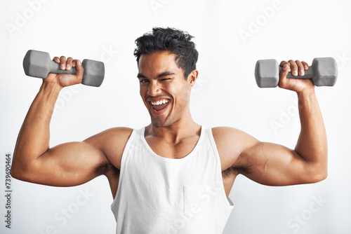 Fitness, portrait and happy man with dumbbell in studio gym for weightlifting, sports or strength on white background. Training, face or male bodybuilder with power, performance or bicep challenge