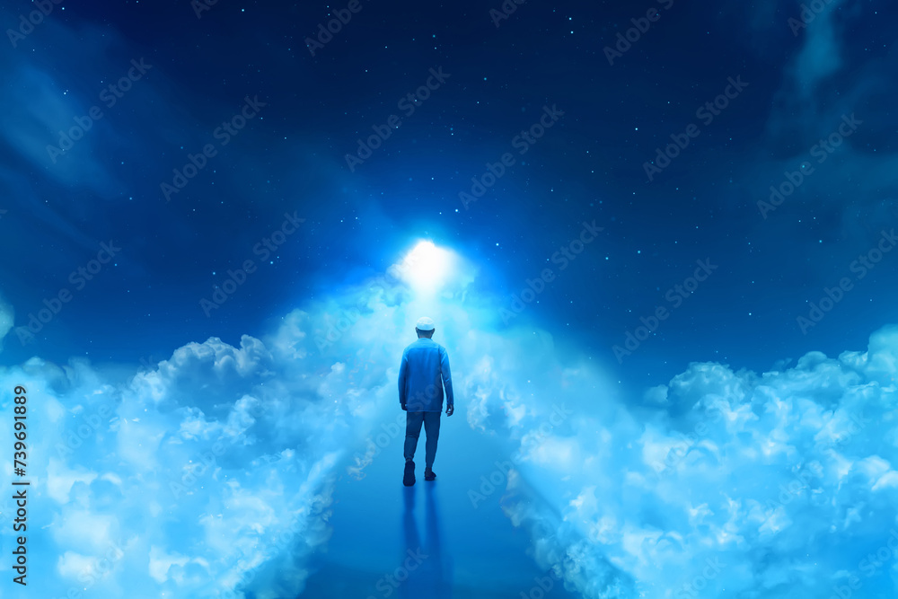 Back view of young arab man with beard on top, walking forward into shiny light alone over the cloud at beautiful blue night sky with stars