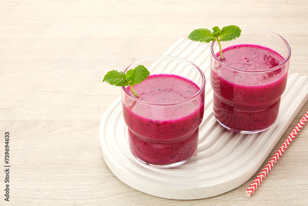 Delicious dragon fruit or pitahaya smoothie and fresh fruits with mint leaves
Delicious dragon fruit or pitahaya smoothie and fresh fruits with mint leaves