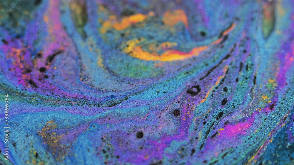 Shimmering liquid background. Sparkling fluid. Acrylic paint motion. Blue purple orange blend stream of wet pigment with black blots in trendy vibrant abstract art.
