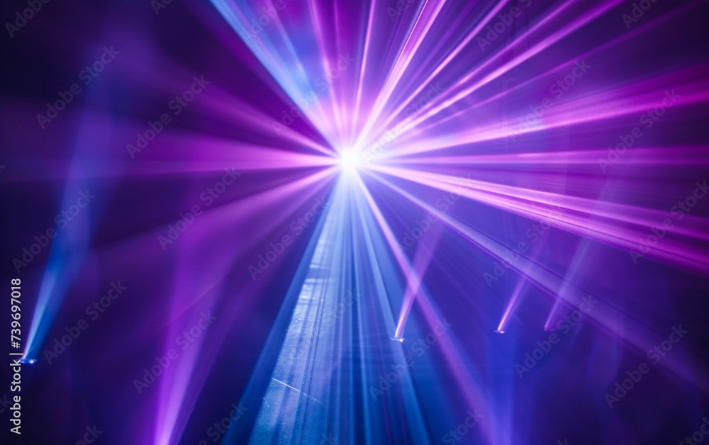 Fototapeta premium Blue and violet beams of bright laser light shining on black background