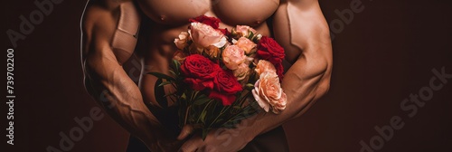 Muscular male arms hold a gift of flowers in their hands. Banner.