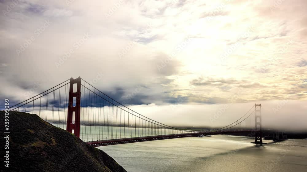 Timelapse shot over the golden gate bridge with white clouds passing by in San Francisco, CA, USA at daytime. Timelapse shot over the golden gate bridge with white clouds passing by in San Francisco, CA, USA at daytime.