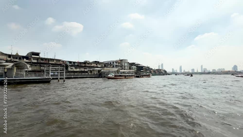Chao Phraya River tour boat with city and other boats in Bangkok Thailand, View from water transport shot