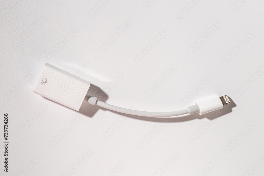 a white lightning cable is sitting on a white table a white lightning cable is sitting on a white table