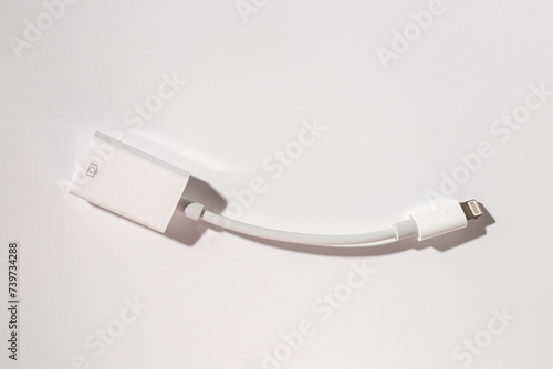 a white lightning cable is sitting on a white table