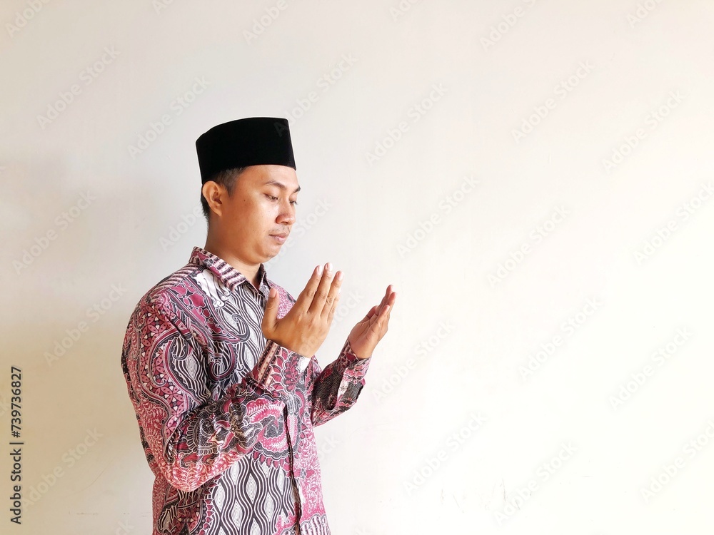 Muslim man praying isolated on white background Muslim man praying isolated on white background