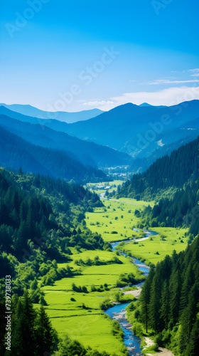 Serene Valley: A Lush Landscape of Green Meadows, Sparkling River, and Majestic Mountains Under a Blue Sky © Manuel