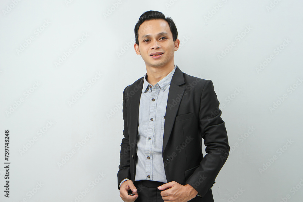Fototapeta premium Happy confident asian indonesian business man in suit on isolated background