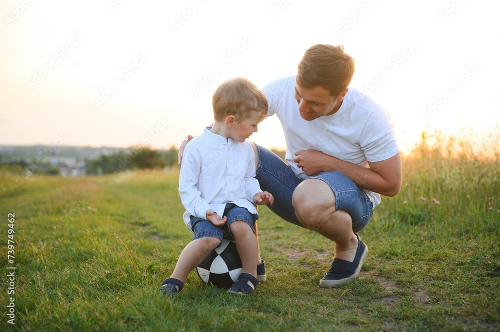 father's day. Dad and son playing together outdoors on a summer. Happy family, father, son at sunset.