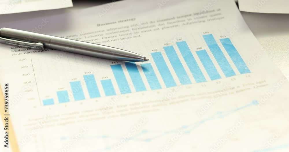 Pen on graph showing analysis of finances of country over year Pen on graph showing analysis of finances of country over year