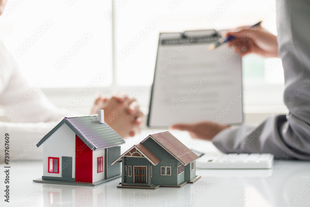 Fototapeta premium Real estate brokers are offering sample homes for customers choose from and recommending estate insurance promotions help protect their properties. Concept of offering real estate and home insurance