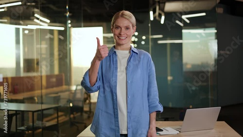 Wallpaper Mural Smiling attractive woman in comfortable clothes showing like sign with hand while standing in collaborative working space. Joyful remote project manager celebrating company progress and success. Torontodigital.ca