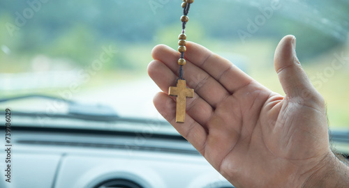 Human hand showing christian cross.