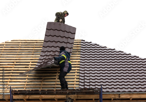 Wallpaper Mural Workers install tiles on the roof of a house in winter Torontodigital.ca