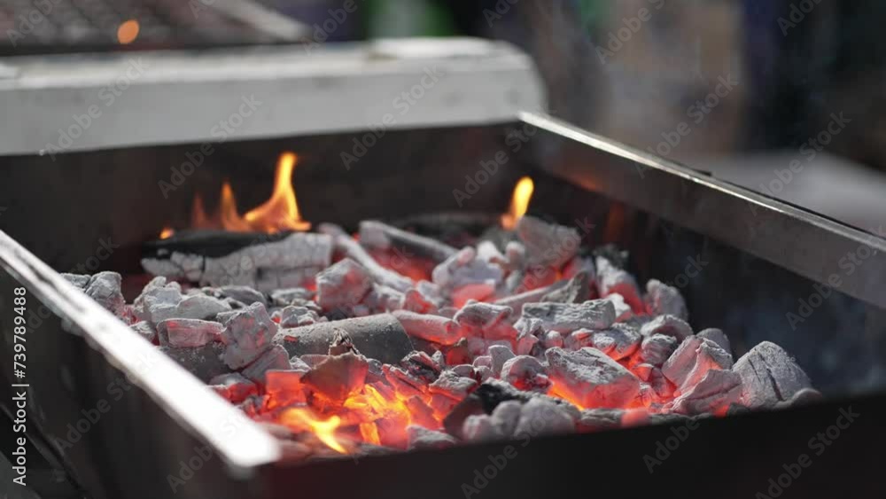 Hot coals and flames in a barbecue pit Hot coals and flames in a barbecue pit
