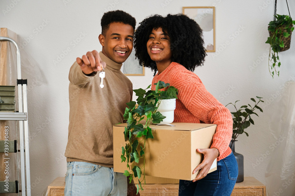 Portrait of happy young black moving in a new home. New residence relocation.