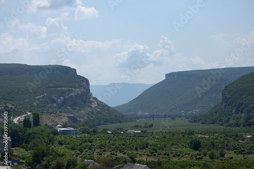 A mountain canyon covered by forest against the sky. Landscape. Belbek River photo