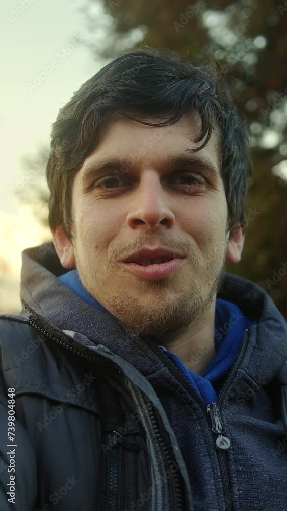 Vertical video. Handsome Young Man with Beautiful Hair Having a Video Call in Pov View Against Sunset Sky and Trees Background Vertical video. Handsome Young Man with Beautiful Hair Having a Video Call in Pov View Against Sunset Sky and Trees Background