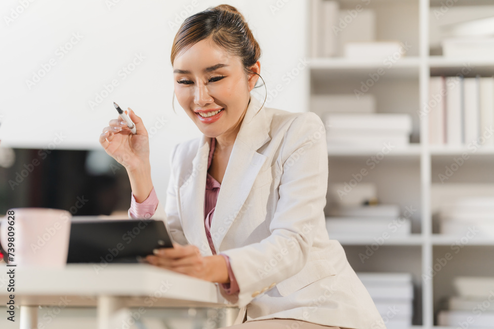 Asian woman working through laptop. business woman busy working with laptop computer at office Asian woman working through laptop. business woman busy working with laptop computer at office