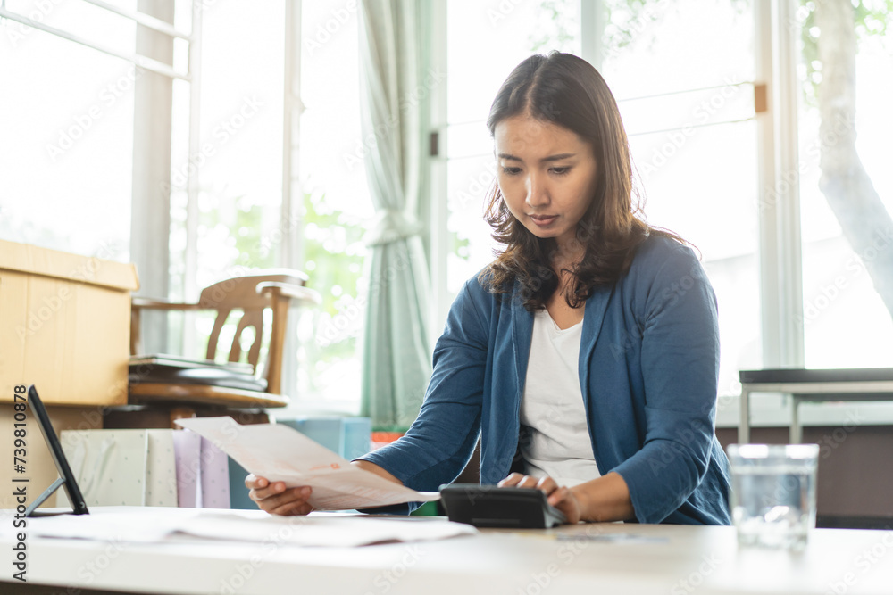 Asian women worry about monthly expense and credit card debt. Asian women worry about monthly expense and credit card debt.