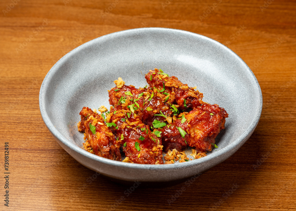Buffalo chicken wings with fried onions in a plate. Buffalo chicken wings with fried onions in a plate.
