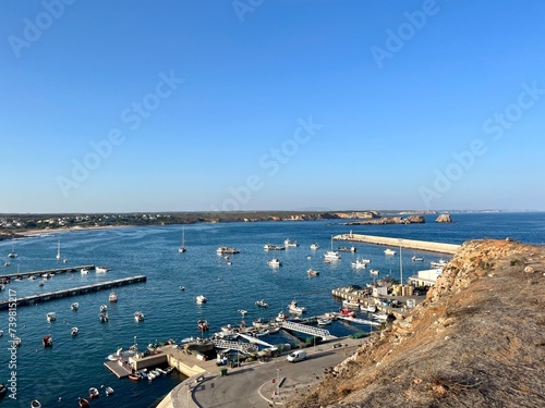 View to the small dock with yachts and boats, ocean coast, blue sky