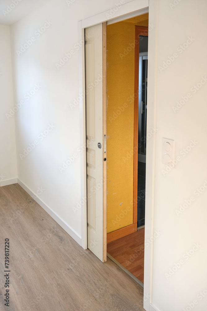 Pocket door in a white plasterboard wall (sliding door inside a wall) Pocket door in a white plasterboard wall (sliding door inside a wall)