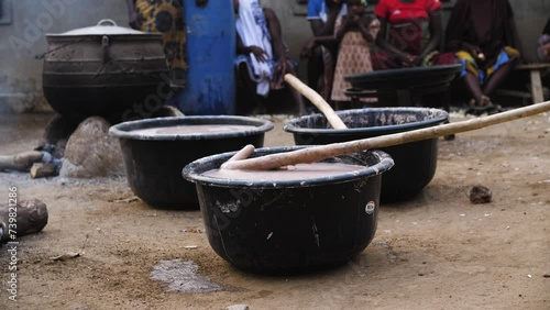 9 jan. 2024,Gwalada,Nigeria:Africa woman preparing popular drink consumed and  breakfast pap  food (akamu,Ogi,kunu) .fermented cereal pudding  made from maize, sorghum, guinea corn or millet. photo
