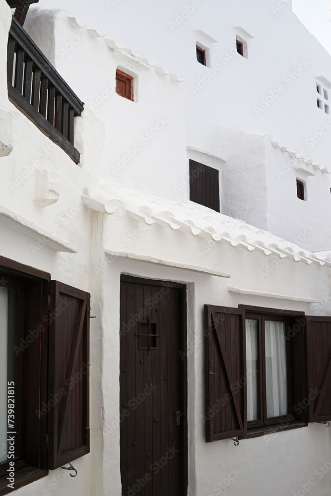 Exterior Spanish architecture and building design of The quaint old fishing village of Binibeca Vell (Binibèquer Vell), white houses form a small labyrinth of narrow, cobbled corridors- Menorca, Spain