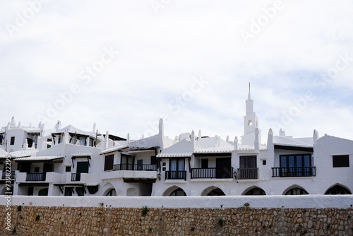 Exterior Spanish architecture and building design of The quaint old fishing village of Binibeca Vell (Binibèquer Vell), white houses form a small labyrinth of narrow, cobbled corridors- Menorca, Spain photo