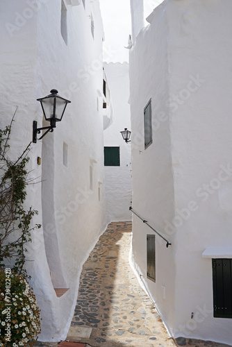 Exterior Spanish architecture and building design of The quaint old fishing village of Binibeca Vell (Binibèquer Vell), white houses form a small labyrinth of narrow, cobbled corridors- Menorca, Spain photo