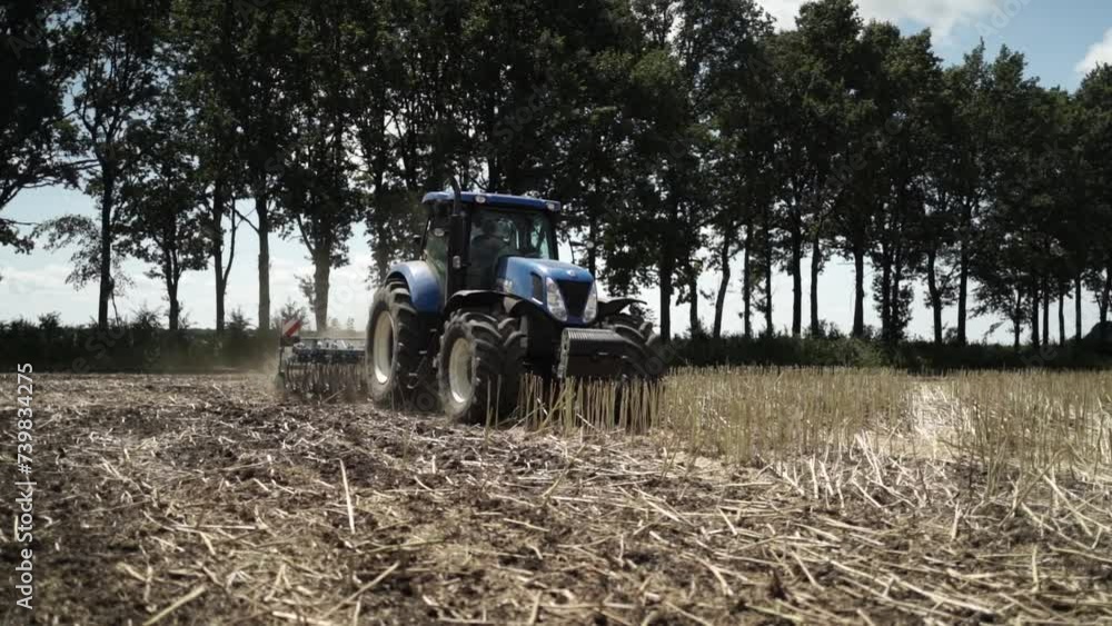 Tractor working on the field doing tillage Tractor working on the field doing tillage