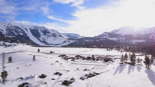 Mammoth Lakes Sierra Mountains California aerial cinematic drone flight winter spring sunny beautiful snow covered town June Lake Crowley Bishop The Station skatepark forward movement photo