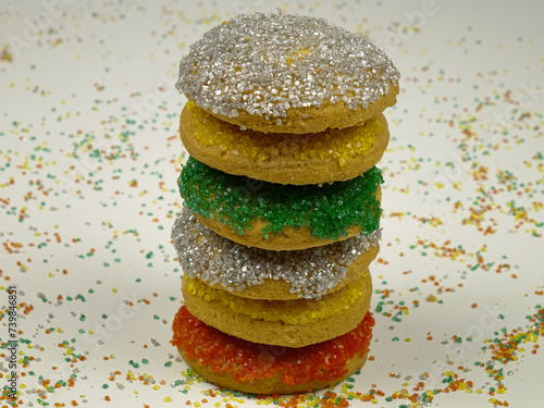 A stack of sugar cookies that are sprinkled with colorful sugar