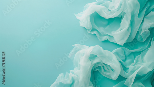 Turquoise background and fabric folds. Top view, copy space