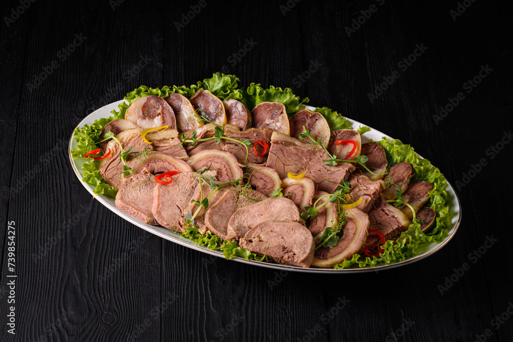 sliced meat on a black wooden background