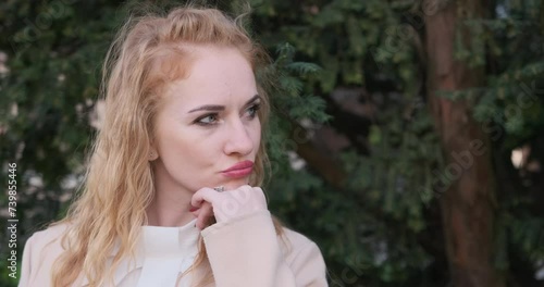 Frustrated angry young woman. Girl looks to side and looks resentfully at camera pursing her lip. Girl was offended. photo