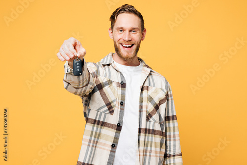 Young fun Caucasian man wear brown shirt casual clothes hold in hand classic black film making clapperboard stretch hand to camera isolated on plain yellow orange background studio. Lifestyle concept.