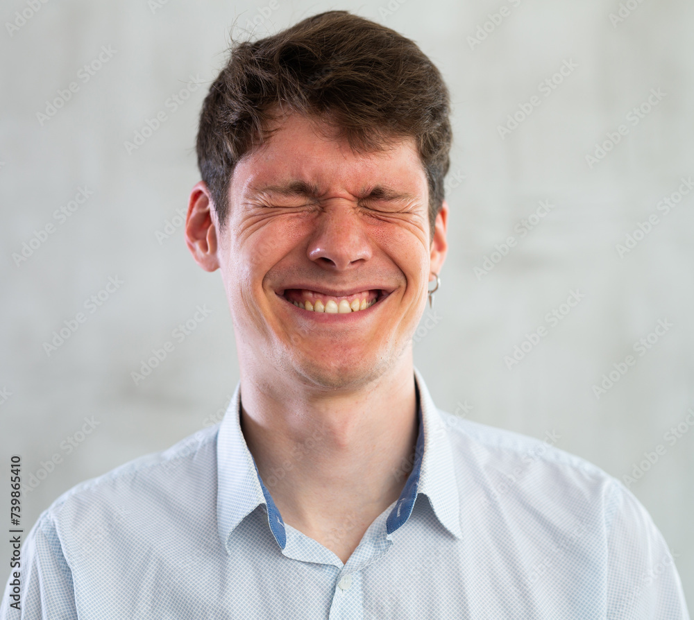 Fototapeta premium Portrait of young smiling guy in studio