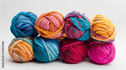Multicolored yarn balls on a white background.