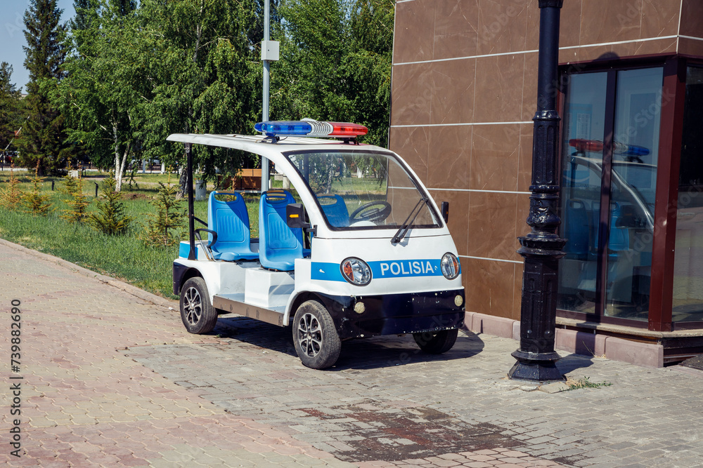 Electric Police Patrol car. Police golf car near police station on city beach
