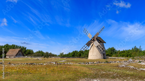 Typical windmill and a barn with thatched roof on the island of Faro, Gotland