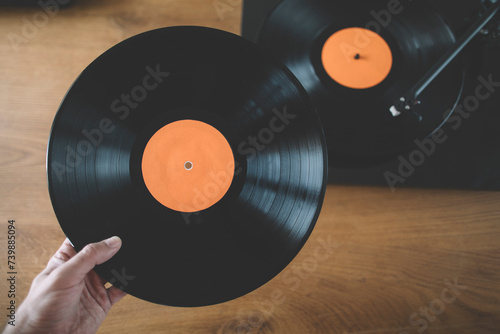 Hand holding long play vinyl record
