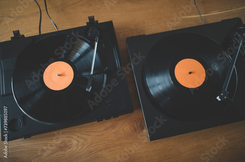 Two turntables playing vinyl records