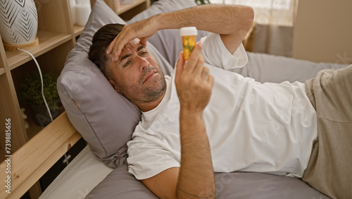 Photography Distressed young hispanic man waking up ill, forced to tackle the day with a pil