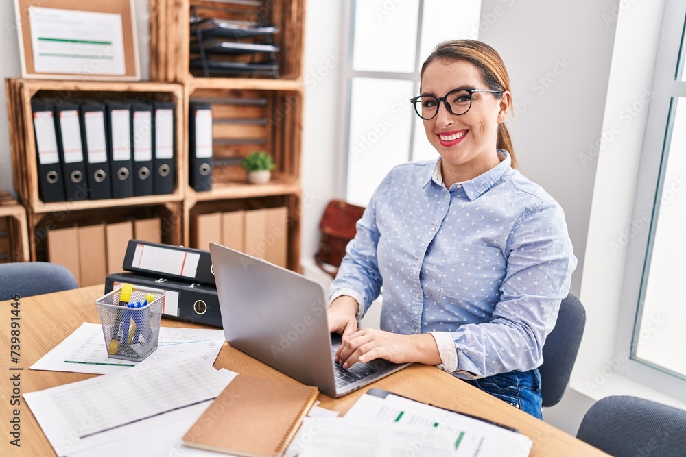 Fototapeta premium Young beautiful hispanic woman business worker using laptop working at office