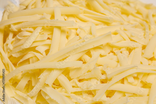 grated mozzarella on a plate, seen close up.